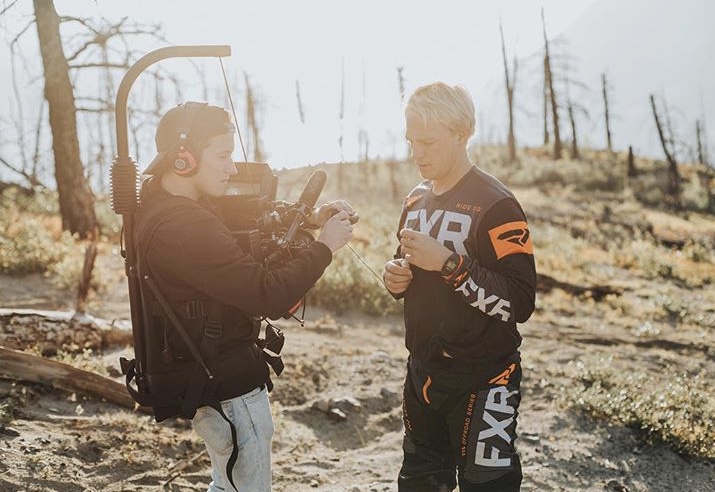 Daniel Sedlak working with a camera operator on an outdoor motorcycle shoot